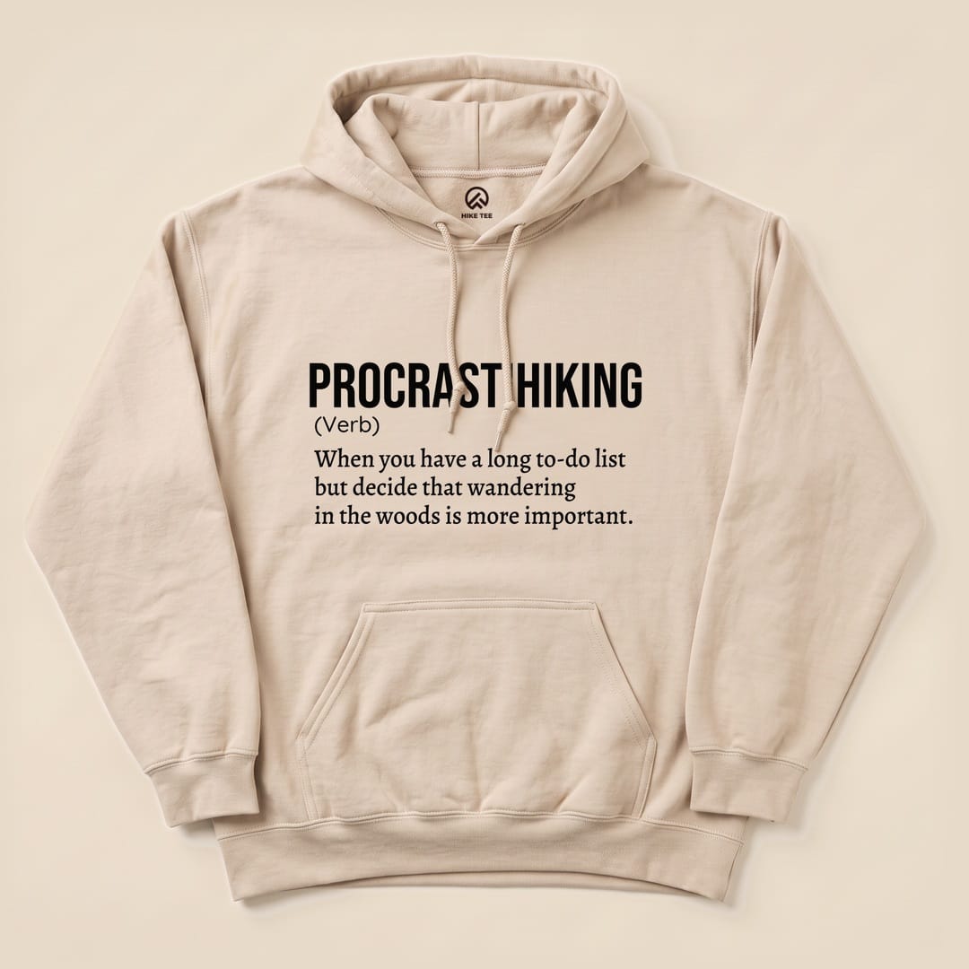 A beige "Procrastihiking Definition Hoodie" features the humorous definition of "procrastihiking" printed in bold black text.