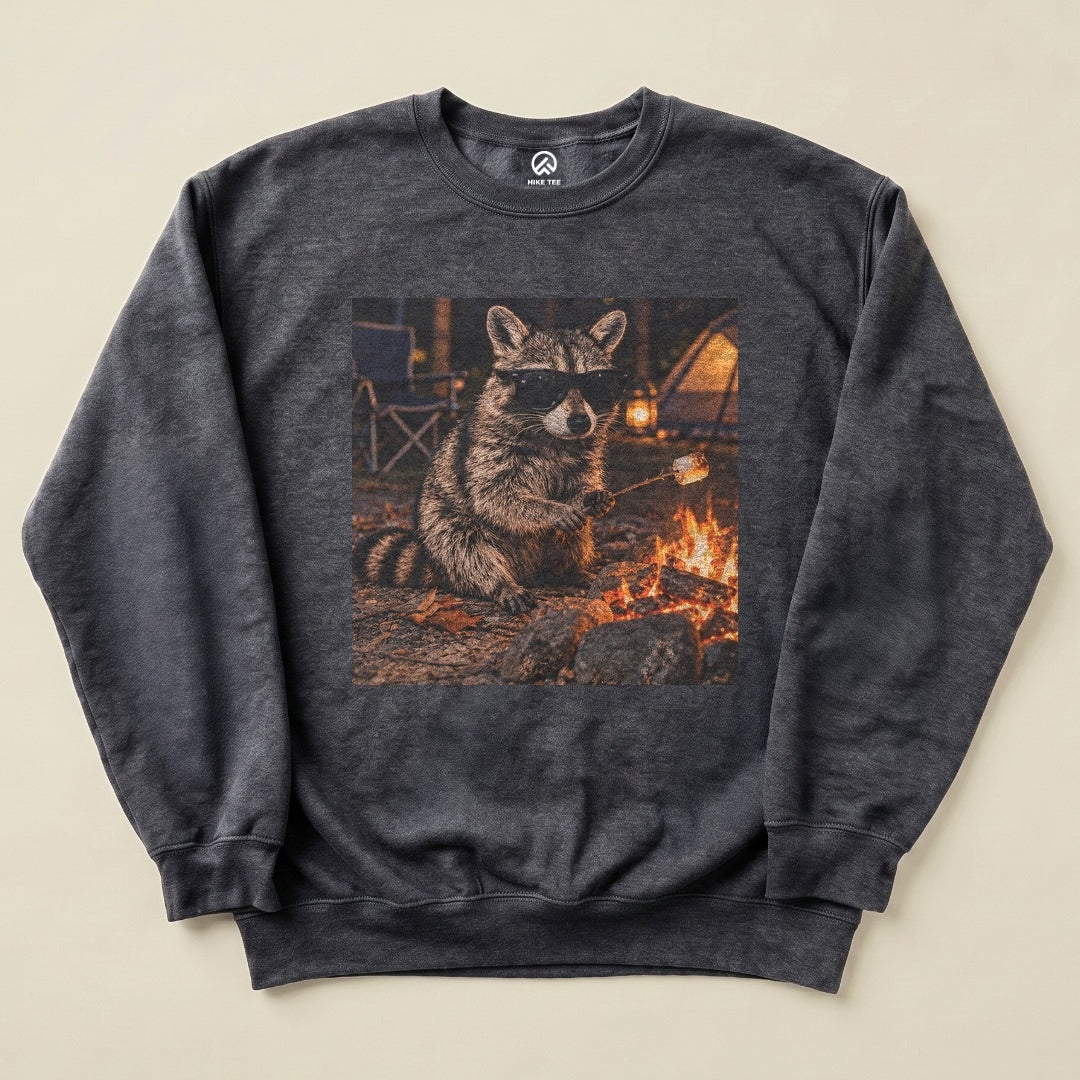 Dark Heather Raccoon in Sunglasses Sweatshirt with a raccoon in sunglasses roasting a marshmallow by the campfire graphic