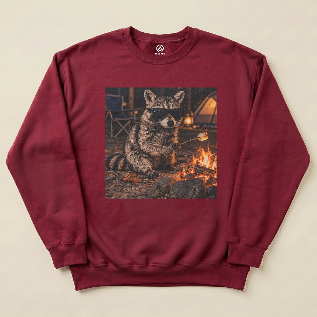 Maroon Raccoon in Sunglasses Sweatshirt with a raccoon in sunglasses roasting a marshmallow by the campfire graphic
