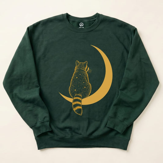 Graphic sweatshirt featuring a raccoon sitting on a crescent moon with a starry design, titled "Raccoon Moon Sweatshirt.