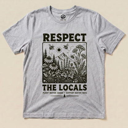 A gray graphic t-shirt featuring the "Respect The Locals Shirt" design with floral illustrations and the slogan, "PLANT NATIVE SEEDS - SUPPORT NATIVE BEES.