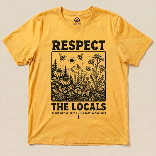 A flat lay of a yellow graphic t-shirt featuring the “Respect The Locals Shirt” design with floral elements and bees.