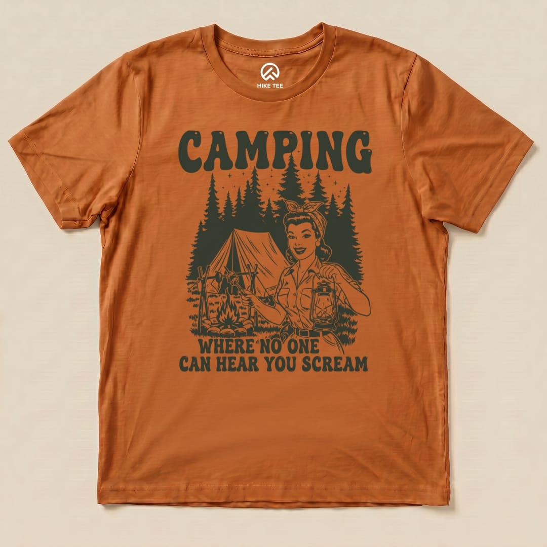 The Retro Camping Scream Shirt features a woman holding a lantern with the slogan "Camping: Where No One Can Hear You Scream" and a tent and trees graphic.
