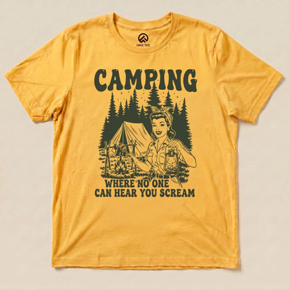 A flat lay of a graphic t-shirt featuring the slogan "CAMPING WHERE NO ONE CAN HEAR YOU SCREAM" alongside a retro camping scene.