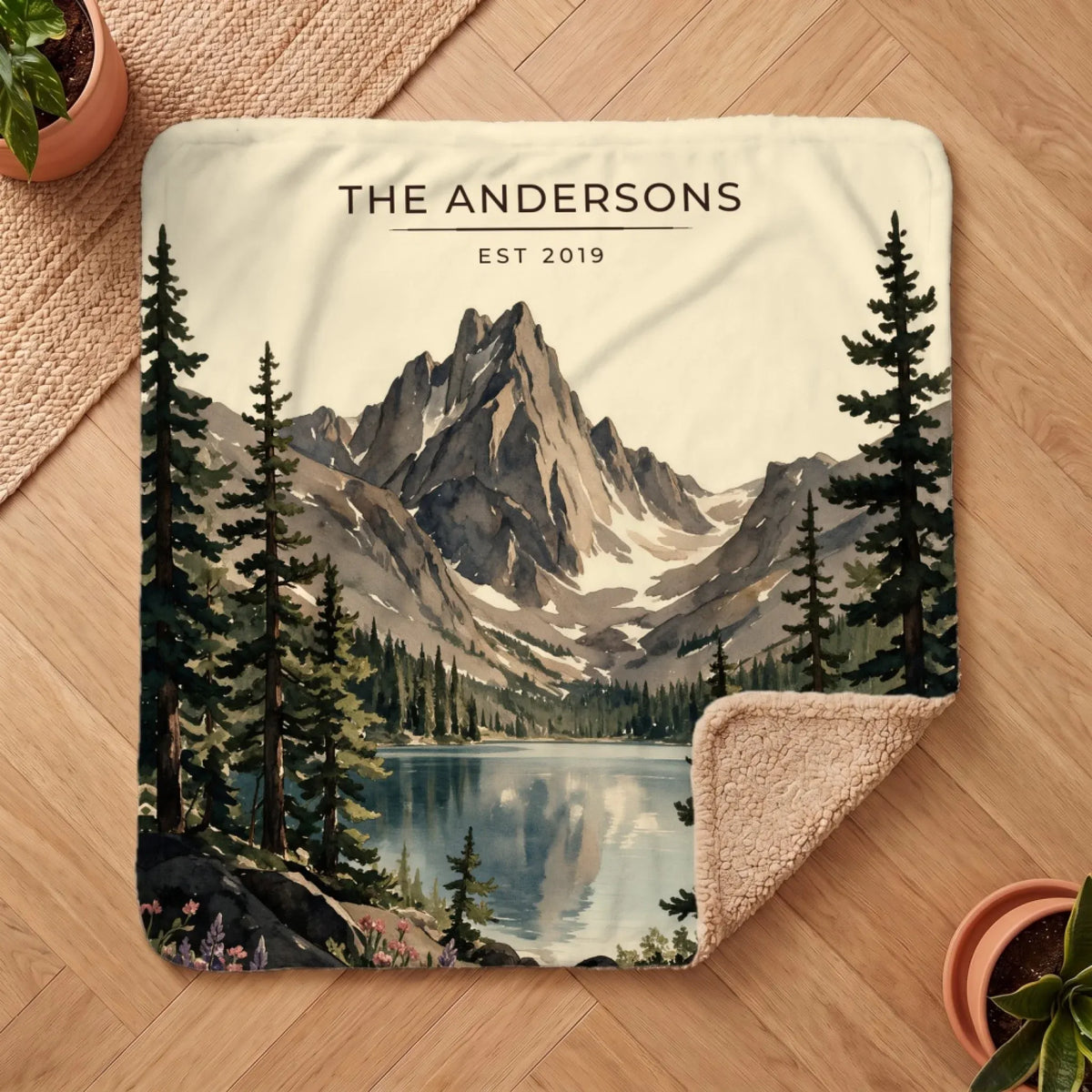 Personalized Rocky Mountain Dream Lake Sherpa Blanket on a wooden floor with the cozy sherpa back showing