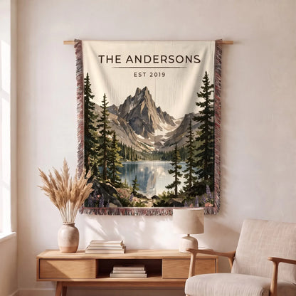 Personalized Rocky Mountain Dream Lake Woven Blanket hanging on a wall, family name woven in