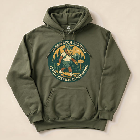 The Sasquatch Sighted Hoodie features a humorous graphic of Sasquatch walking on a trail, with the text "It was just Dad in flip-flops.