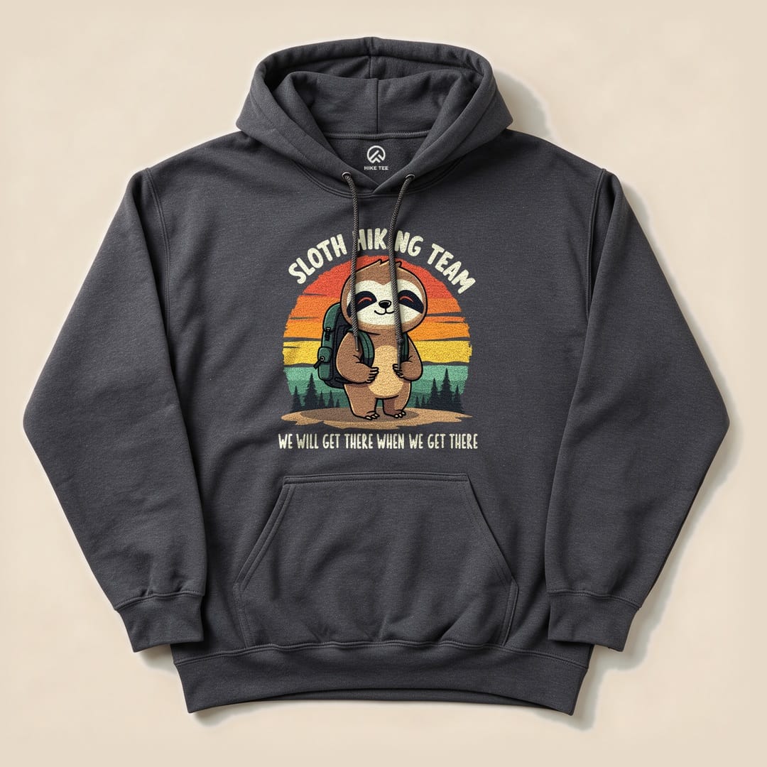 Graphic t-shirt features a cute sloth with a backpack and the text "Sloth Hiking Team" and "We will get there when we get there.