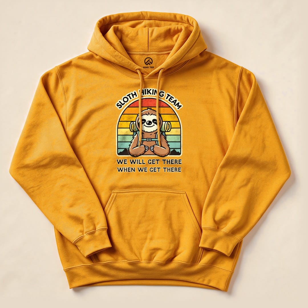 A graphic t-shirt featuring a sloth holding hiking gear, with the text “Sloth Hiking Team” and “We Will Get There When We Get There.”