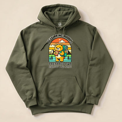 A green hoodie featuring a playful bear graphic with a backpack, reading “Prepared for Snacks and Naps Hiking Bear Hoodie.”