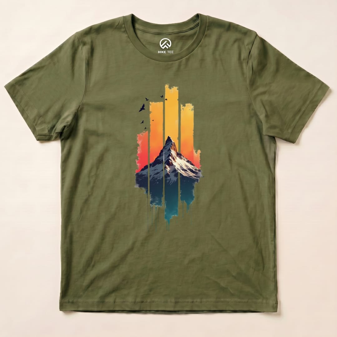 The graphic t-shirt features a colorful mountain against a sunset background, highlighting the "Snow Mountain Sunset Shirt" design.