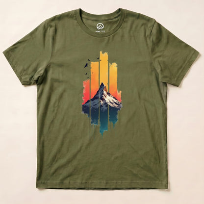 The graphic t-shirt features a colorful mountain against a sunset background, highlighting the "Snow Mountain Sunset Shirt" design.