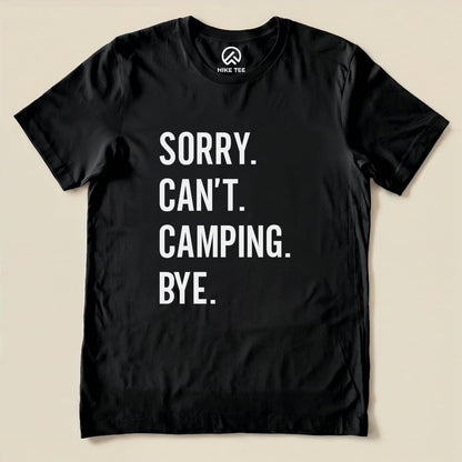 A black graphic t-shirt featuring bold white text reading "Sorry. Can't. Camping. Bye." displayed flat on a neutral background.
