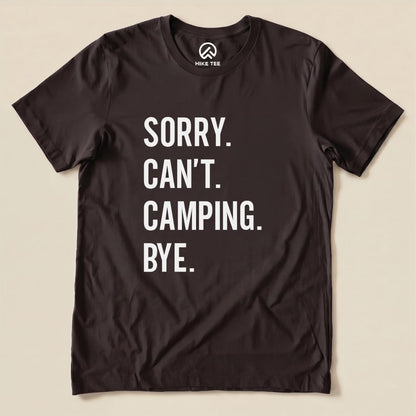 Black graphic t-shirt featuring the text "Sorry. Can't. Camping. Bye." in bold white letters, showcasing a humorous outdoor theme.