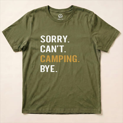 A flat olive green graphic t-shirt displays the slogan "Sorry. Can't. Camping. Bye." in bold letters.