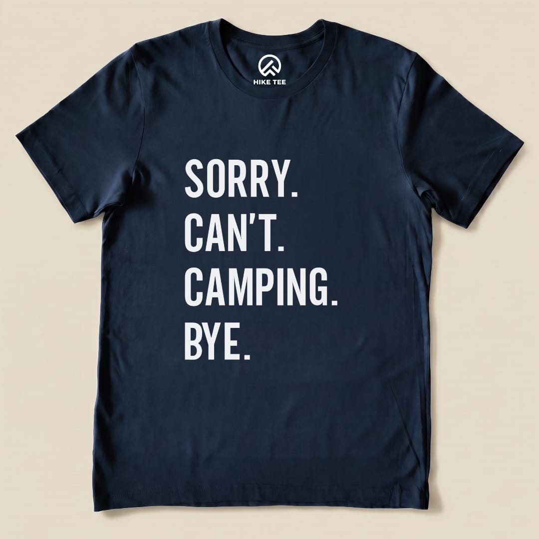 A navy graphic t-shirt featuring the humorous slogan “Sorry. Can’t. Camping. Bye.” displayed prominently in white text.