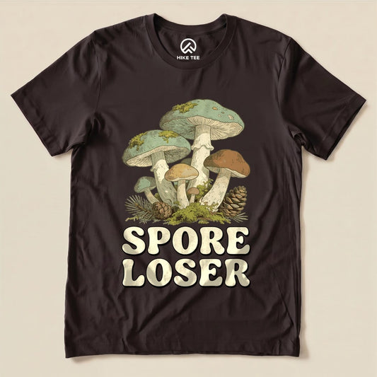 A graphic t-shirt featuring mushrooms with the playful text "SPORE LOSER" prominently displayed below the design.