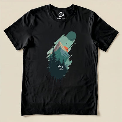 A black graphic t-shirt featuring a mountain scene, trees, and the phrase "Stay Wild" printed prominently below.