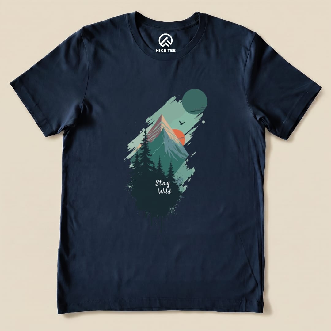 A navy graphic t-shirt featuring a mountain landscape, the phrase "Stay Wild" and elements like a sun and trees.