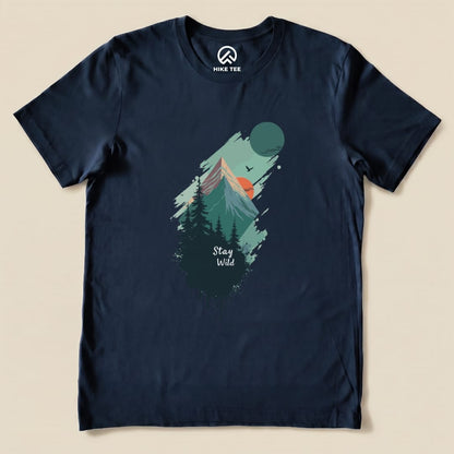 A navy graphic t-shirt featuring a mountain landscape, the phrase "Stay Wild" and elements like a sun and trees.