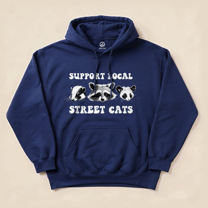 A navy blue "Street Cats Hoodie" features three animal illustrations with the text "Support Local Street Cats" below.