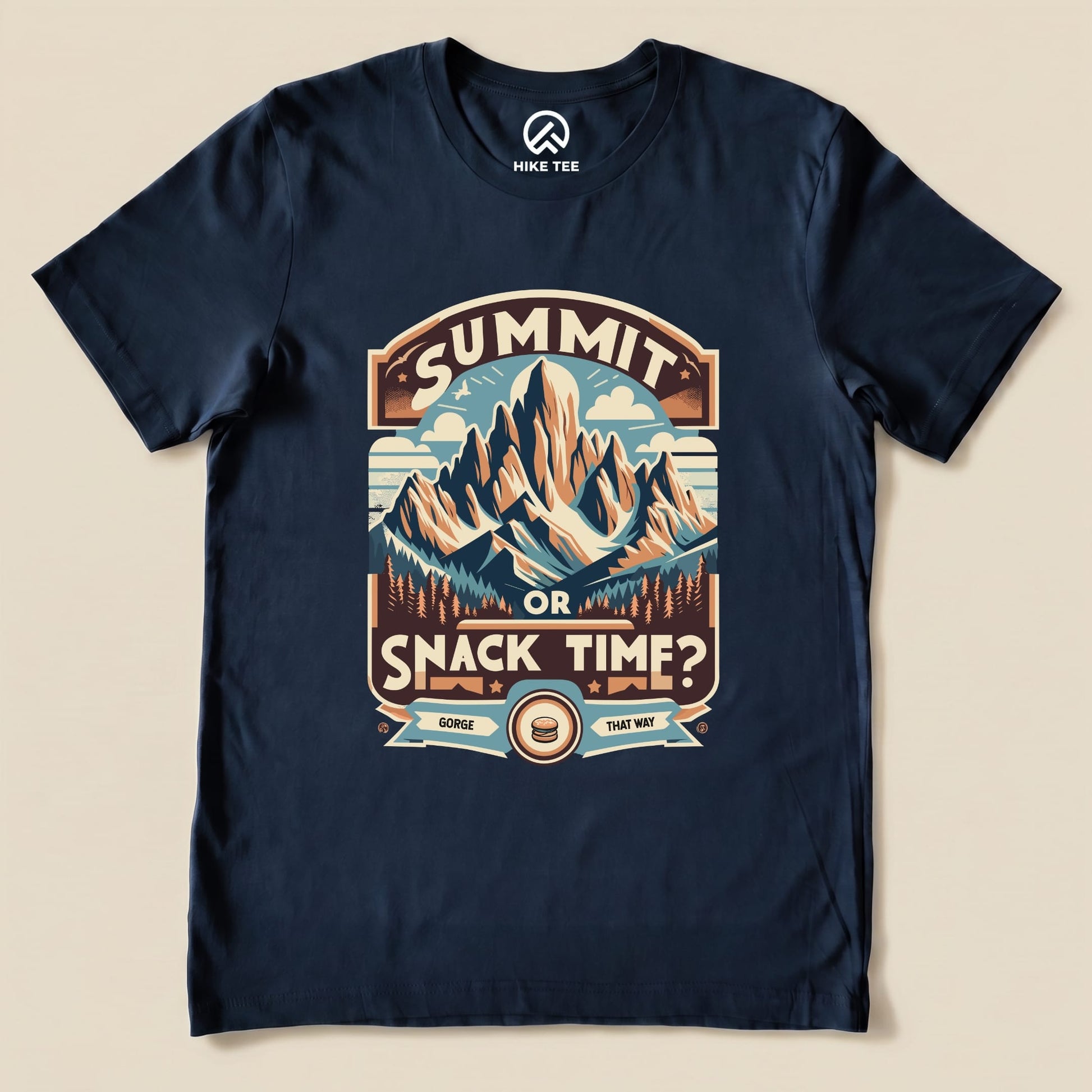 Navy graphic t-shirt featuring a mountain scene with the words "Summit Or Snack Time?" and a playful snack reference.