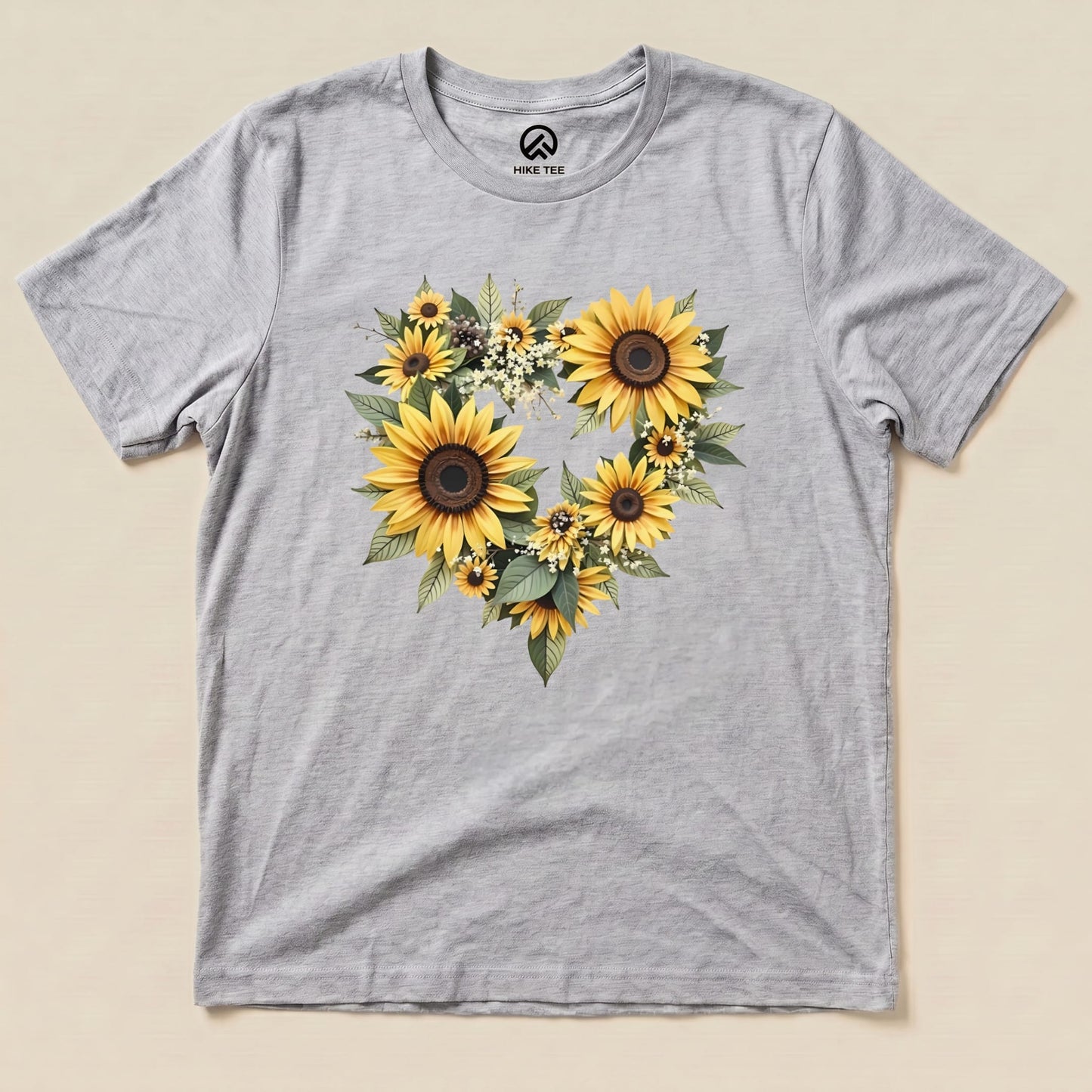 A gray graphic t-shirt featuring a heart design made of sunflowers and greenery, labeled as "Sunflowers Heart Shirt.