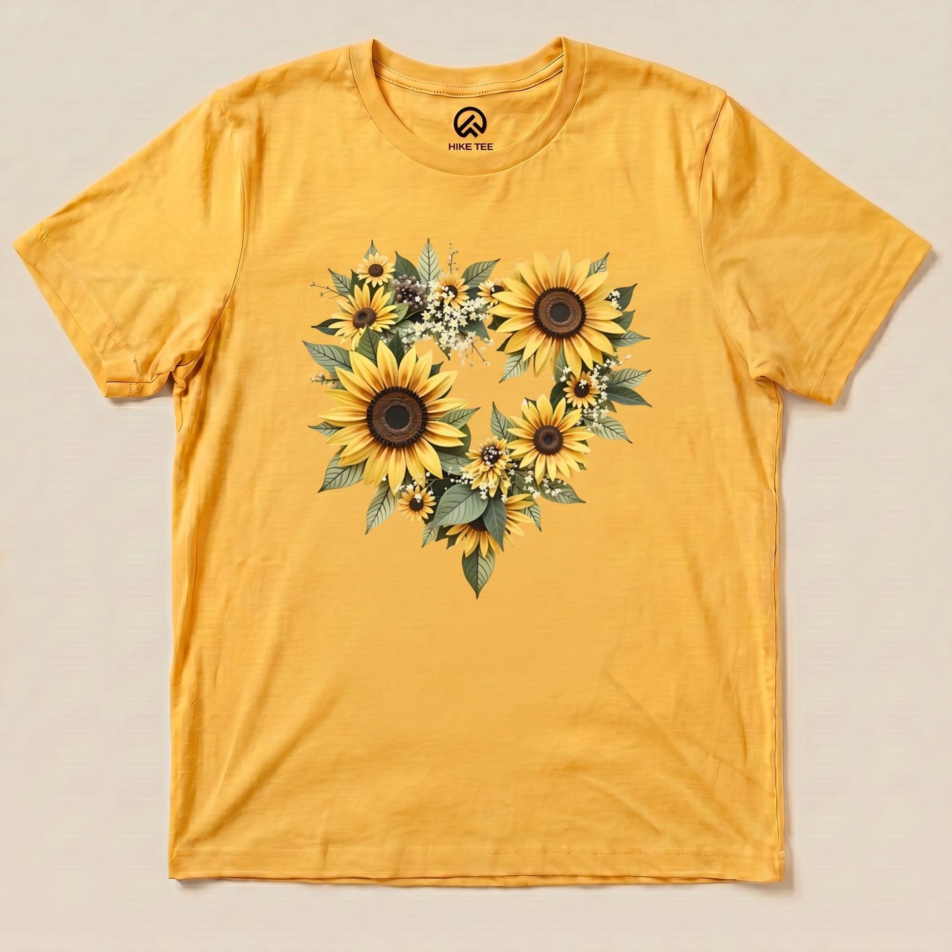 The Sunflowers Heart Shirt features a vibrant yellow fabric adorned with a heart-shaped arrangement of sunflowers and greenery.