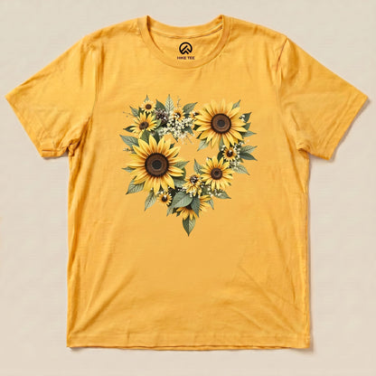 The Sunflowers Heart Shirt features a vibrant yellow fabric adorned with a heart-shaped arrangement of sunflowers and greenery.