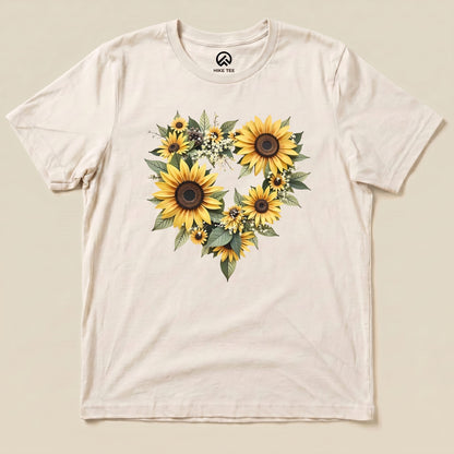 A graphic t-shirt featuring a heart-shaped arrangement of vibrant sunflowers and greenery, labeled "Sunflowers Heart Shirt.