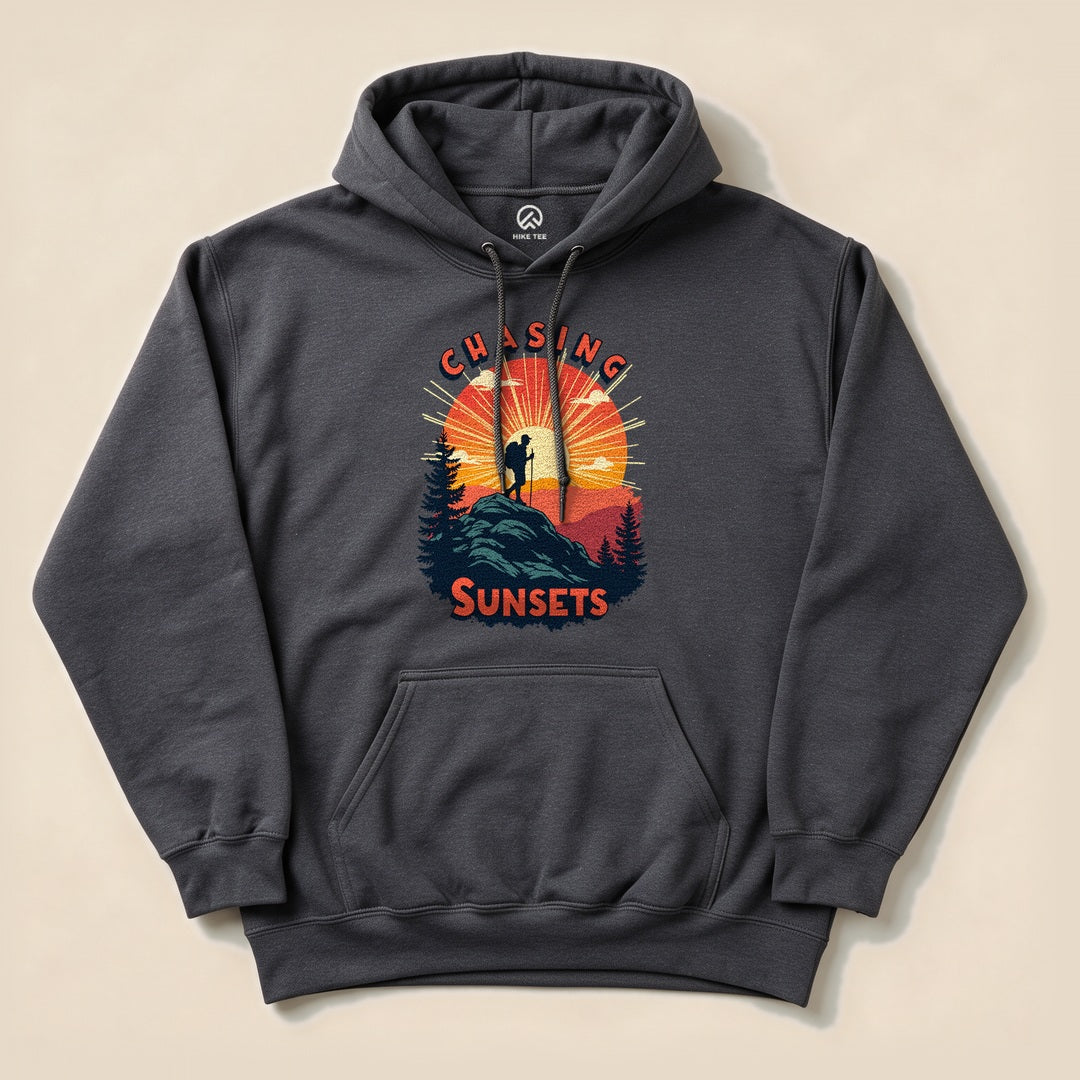 Dark Heather Chasing Sunsets Hoodie with a hiker on a mountain at sunset