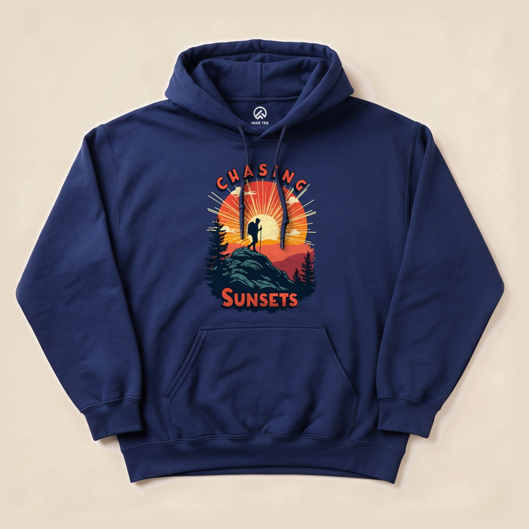 Navy Chasing Sunsets Hoodie with a hiker on a mountain at sunset