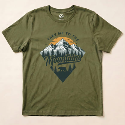 Graphic t-shirt in olive green featuring a mountain design and the text "Take Me To The Mountains" with a bear silhouette.