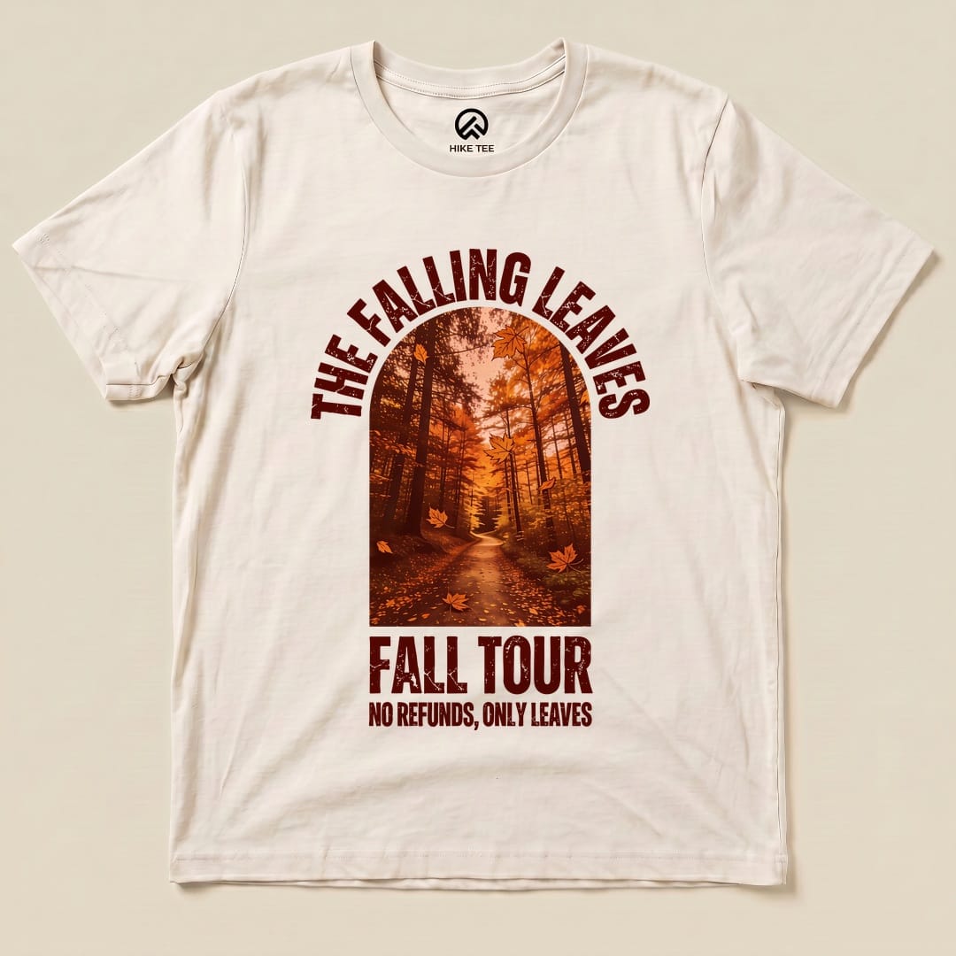 A graphic t-shirt featuring "The Falling Leaves Fall Tour Shirt," showcasing an autumn forest scene with the slogan "NO REFUNDS, ONLY LEAVES.