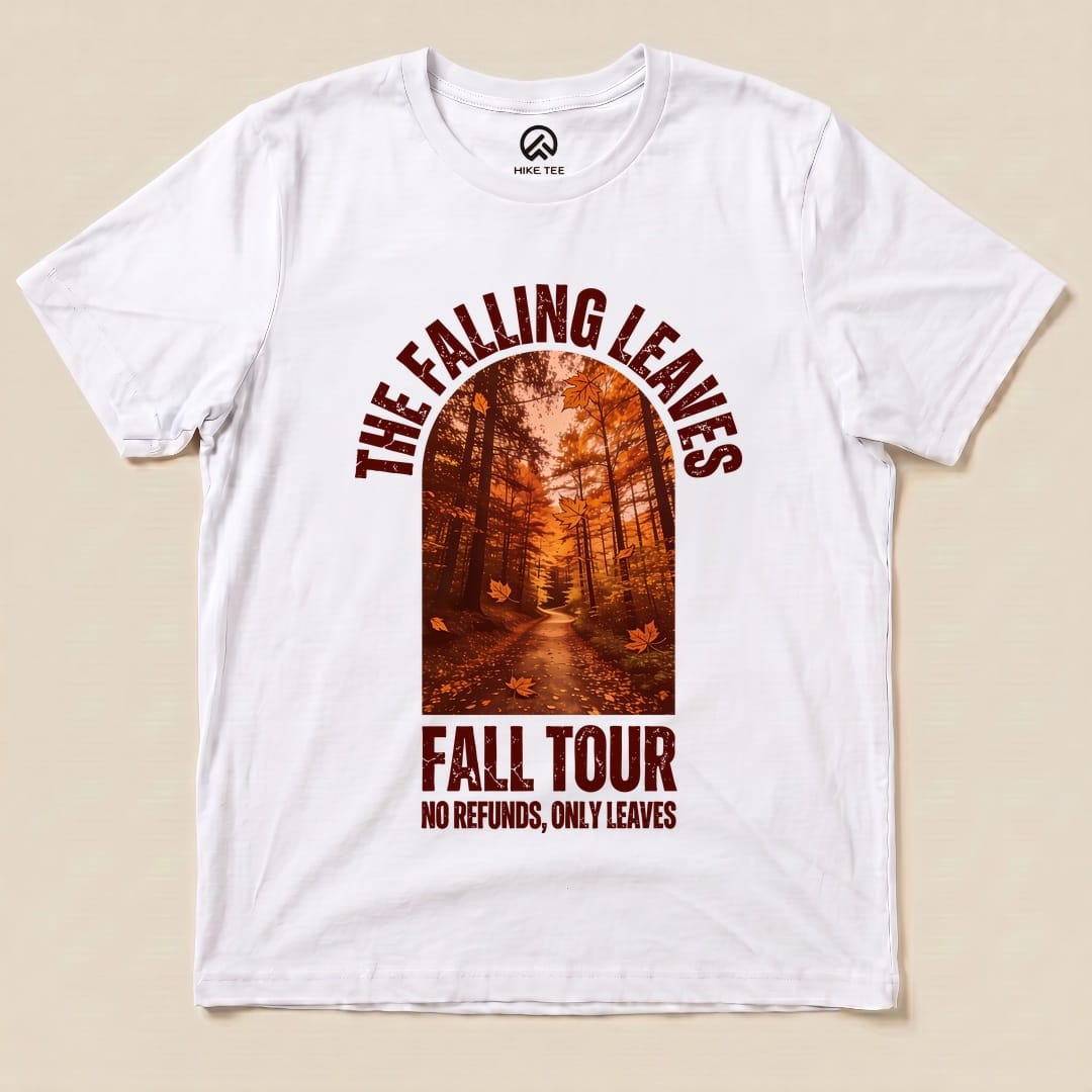 A white graphic t-shirt featuring "The Falling Leaves Fall Tour Shirt" design with a forest pathway and the slogan "NO REFUNDS, ONLY LEAVES.