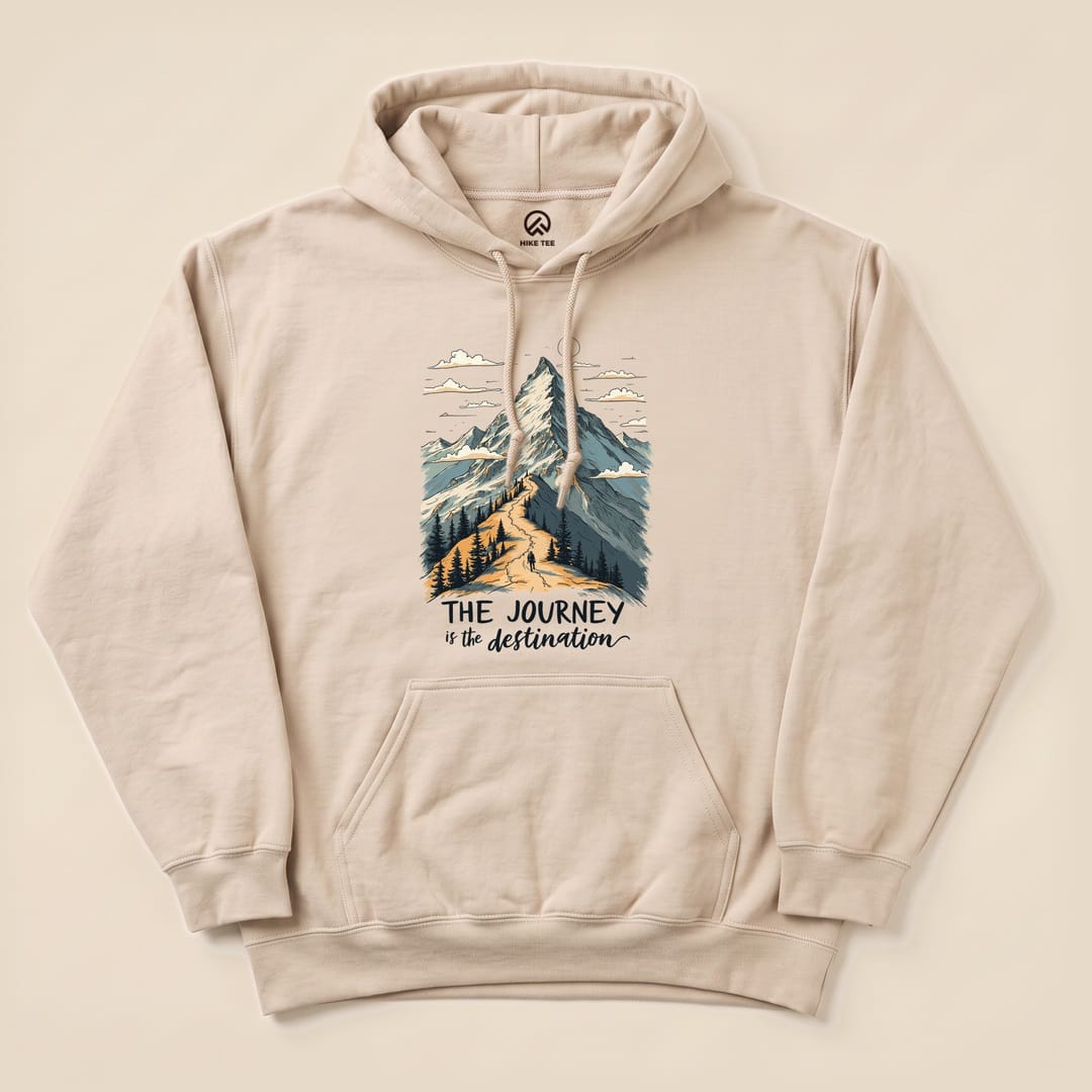 A beige "The Journey Hoodie" features a graphic of a mountain scene with the slogan "THE JOURNEY is the destination" printed below.