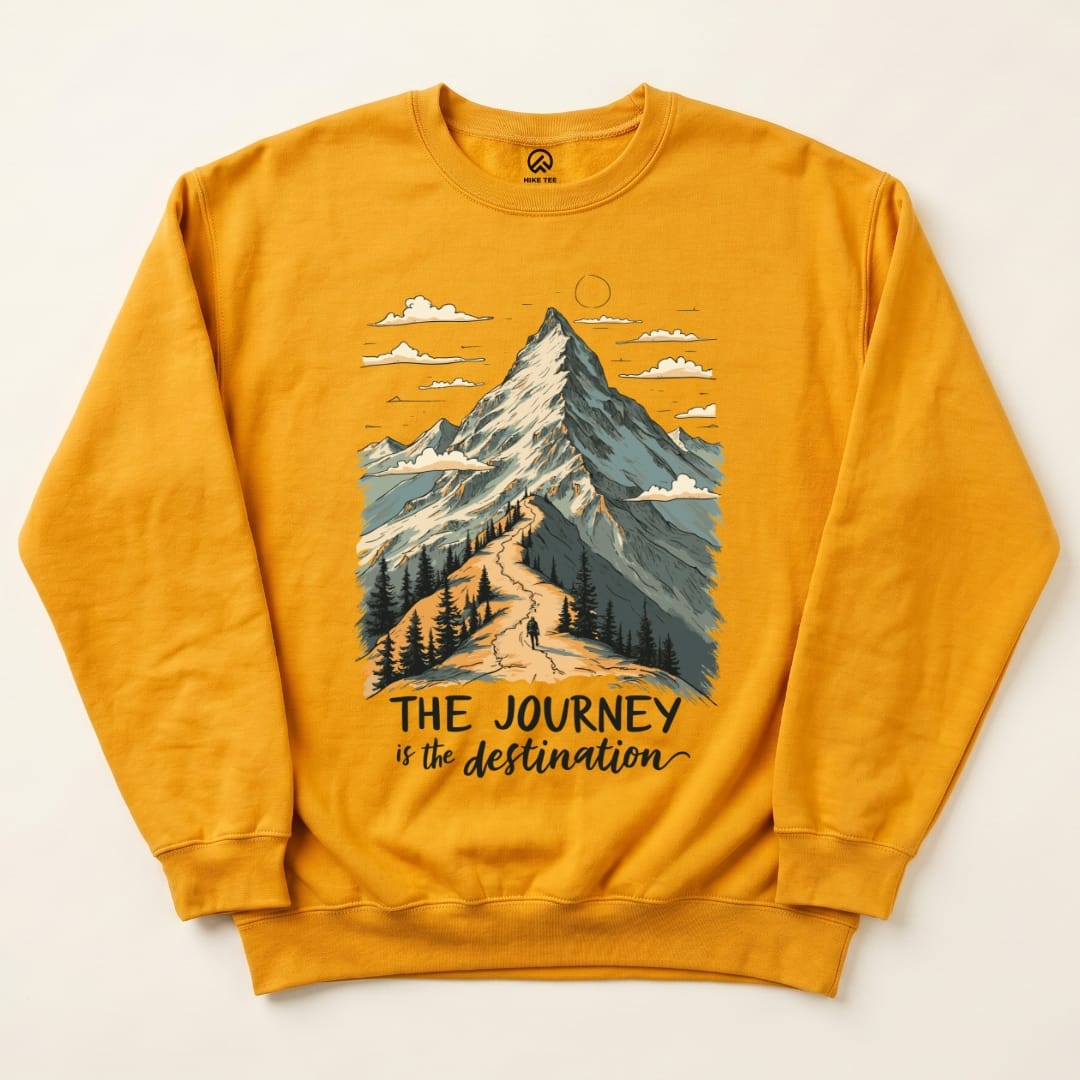 A yellow graphic sweatshirt featuring a mountain design with the phrase "THE JOURNEY is the destination" printed in bold.
