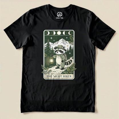 Black The Night Hiker Shirt with a raccoon hiker with a lantern on a moonlit tarot card graphic