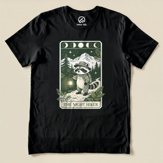 Black The Night Hiker Shirt with a raccoon hiker with a lantern on a moonlit tarot card graphic
