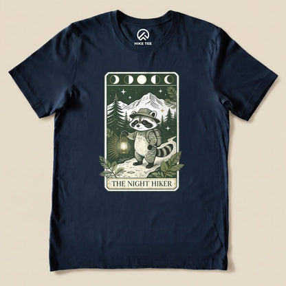 Navy The Night Hiker Shirt with a raccoon hiker with a lantern on a moonlit tarot card graphic