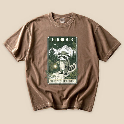 Espresso The Night Hiker T-Shirt with a raccoon hiker with a lantern on a moonlit tarot card graphic