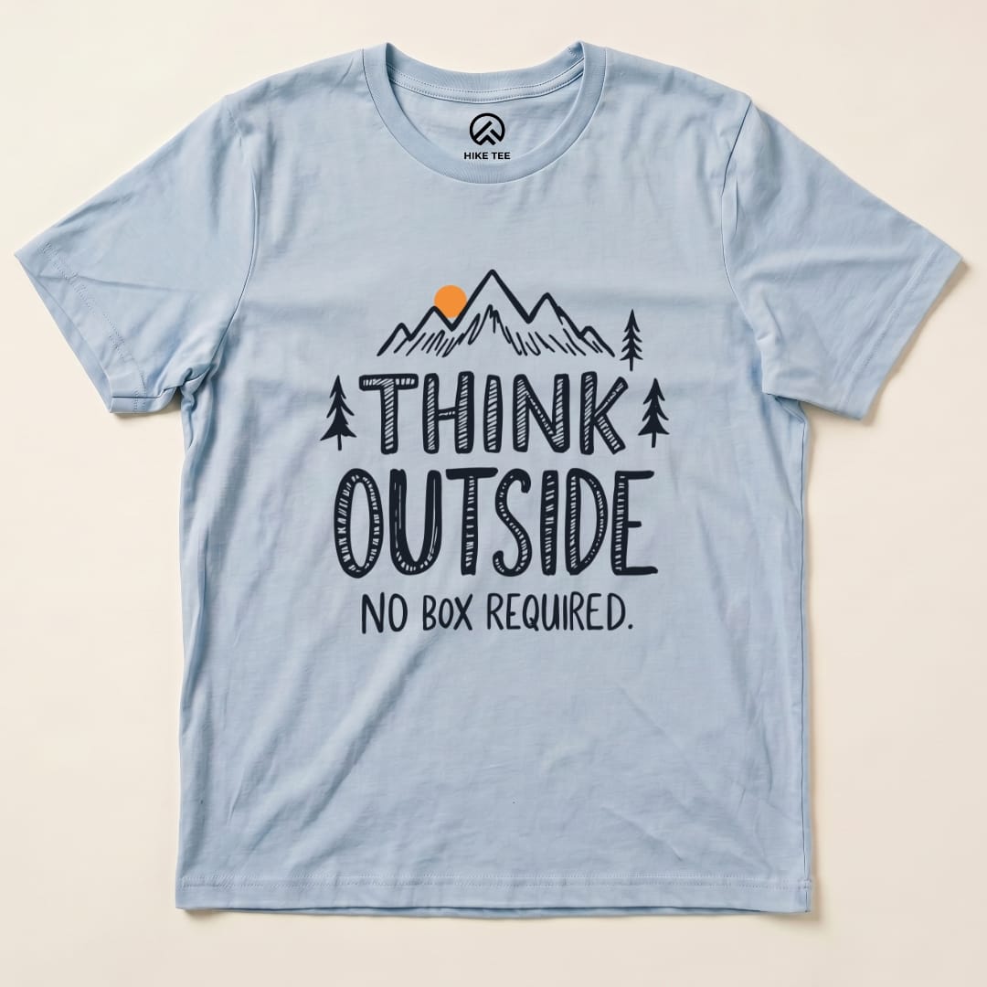 A light blue graphic t-shirt features mountains, trees, and the phrase "Think Outside, No Box Required.