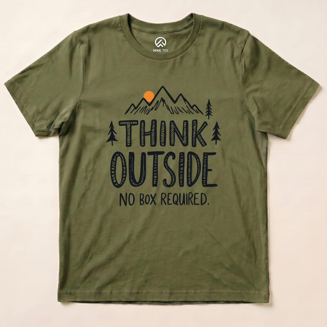 Olive green graphic t-shirt featuring the slogan "THINK OUTSIDE" above a mountain scene and "NO BOX REQUIRED" below.