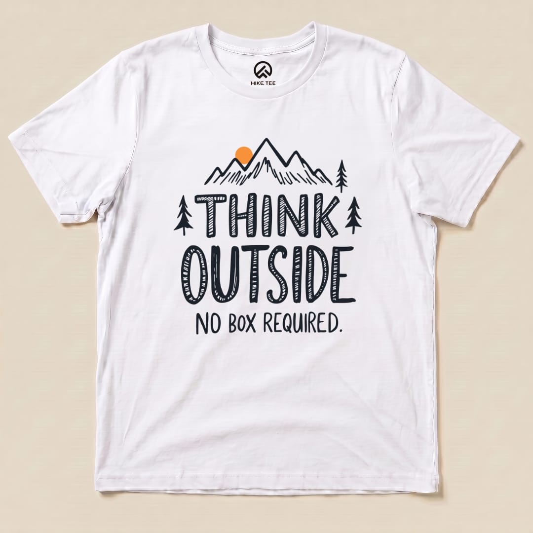 A graphic t-shirt featuring the slogan "THINK OUTSIDE" with mountains and trees, along with the phrase "NO BOX REQUIRED.