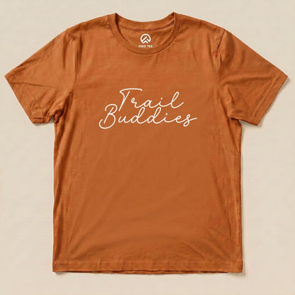 A flat, orange graphic t-shirt featuring the phrase "Trail Buddies" in a playful white script font.