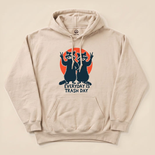 Beige hoodie featuring a graphic of two raccoons with peace signs, captioned "EVERYDAY IS TRASH DAY," labeled as Trash Day Raccoon Hoodie.
