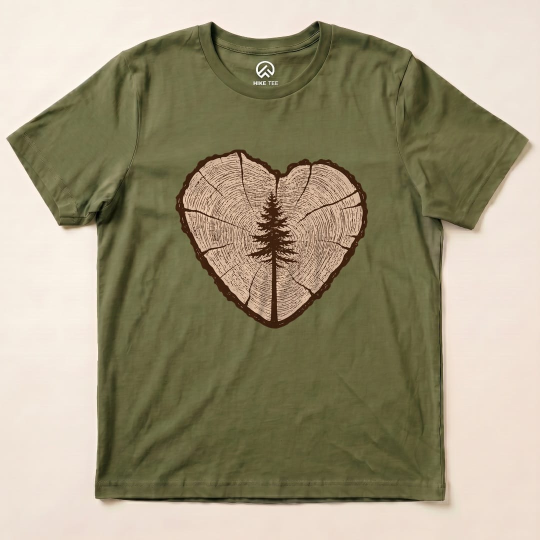 The Tree Ring Heart Shirt features a graphic of a heart-shaped tree ring with a silhouette of a tree in the center.