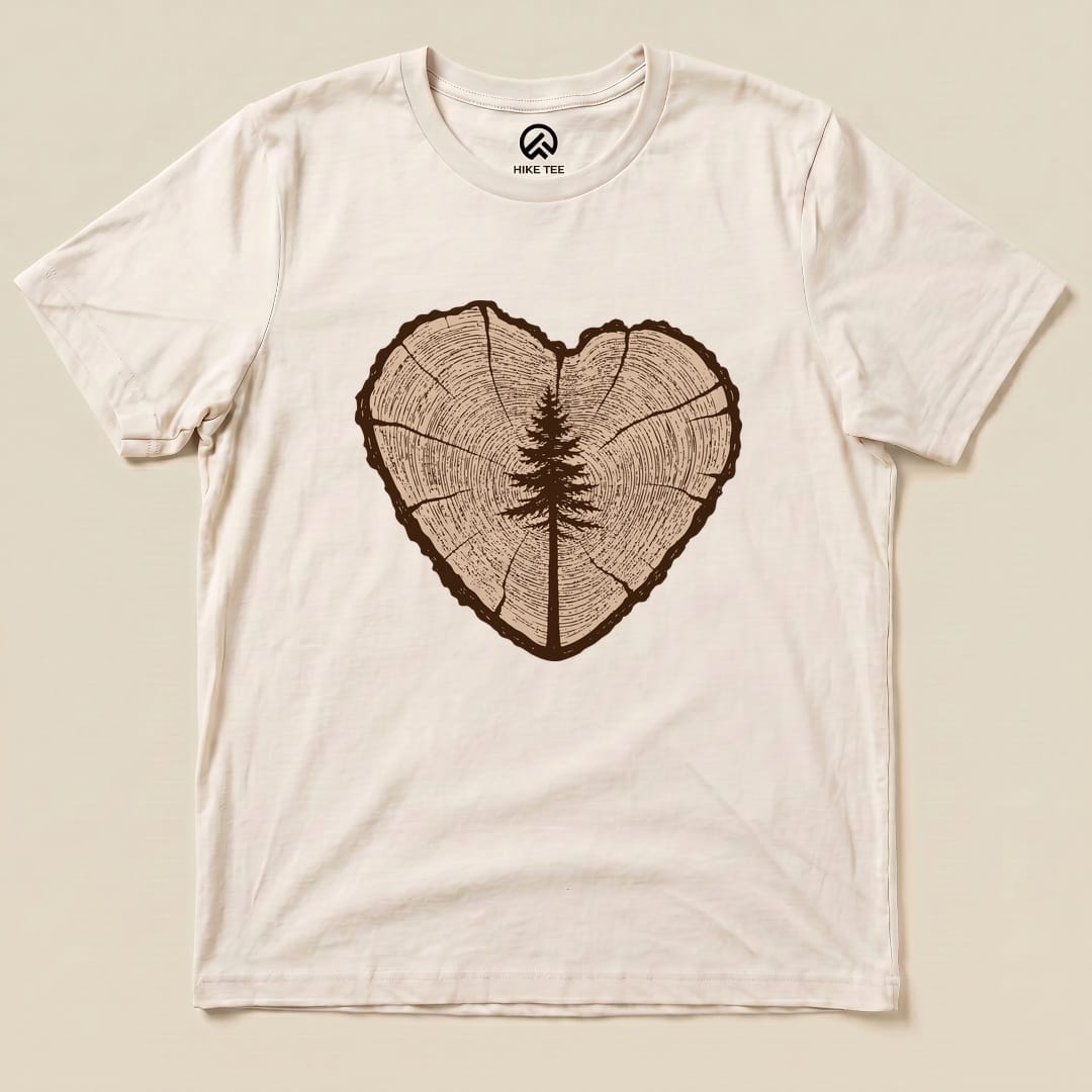 A graphic t-shirt featuring a tree ring design forming a heart shape, with a detailed tree silhouette in the center, labeled "Tree Ring Heart Shirt.