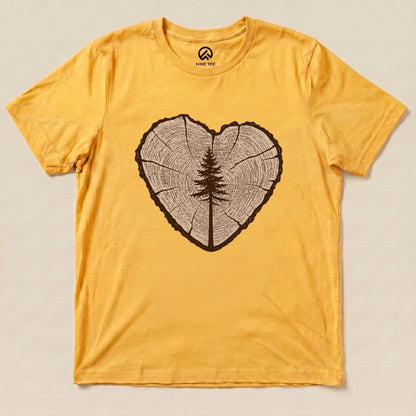 A flat lay of the Tree Ring Heart Shirt, featuring a heart-shaped wood ring graphic with a centered tree design on a yellow background.
