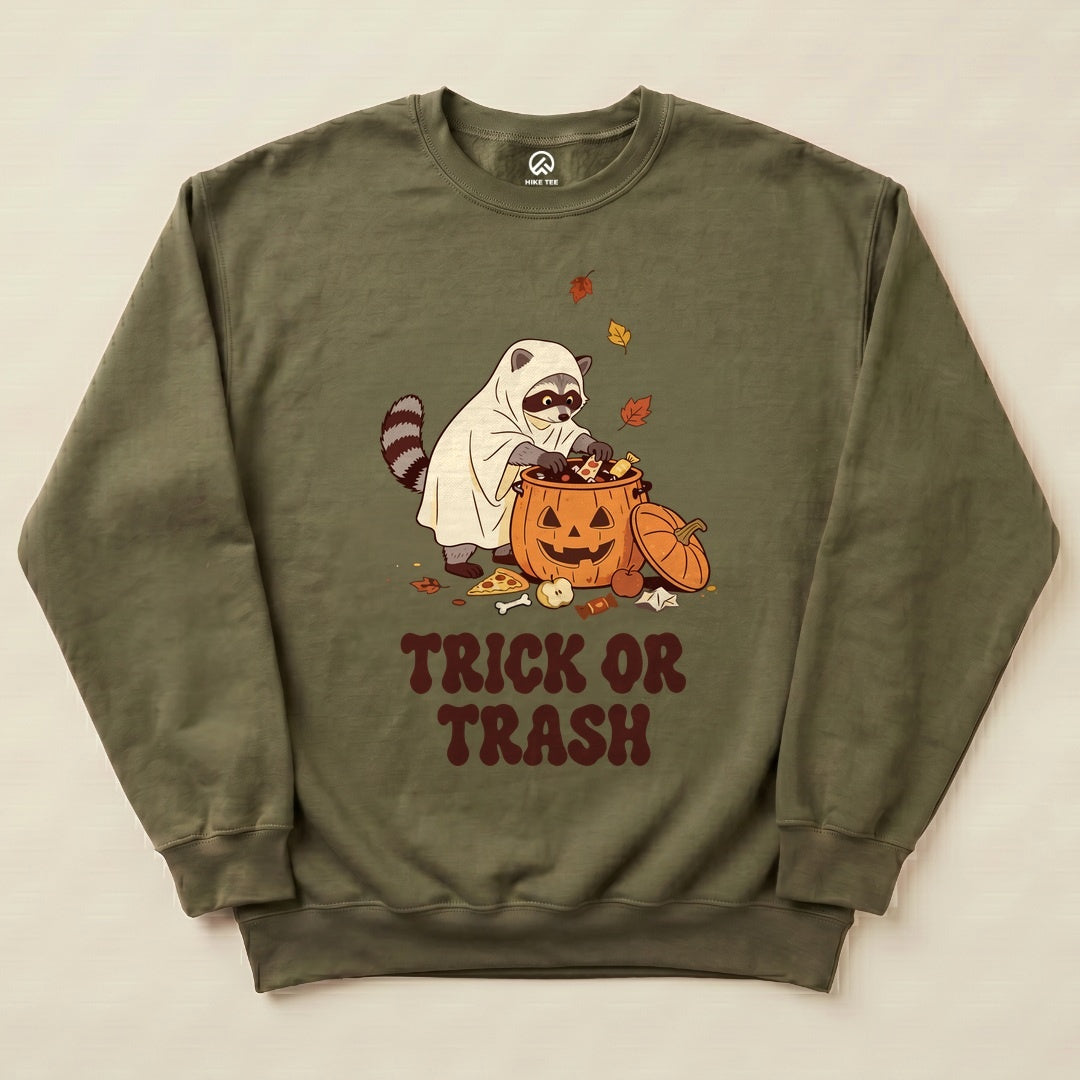 Military Green Trick or Trash Sweatshirt with a raccoon in a ghost costume raiding a pumpkin candy bucket graphic